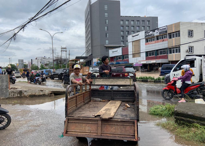 Ada Pedagang Dogan Mengais Rezeki di Balik Banjir yang Menggenangi Kota Palembang